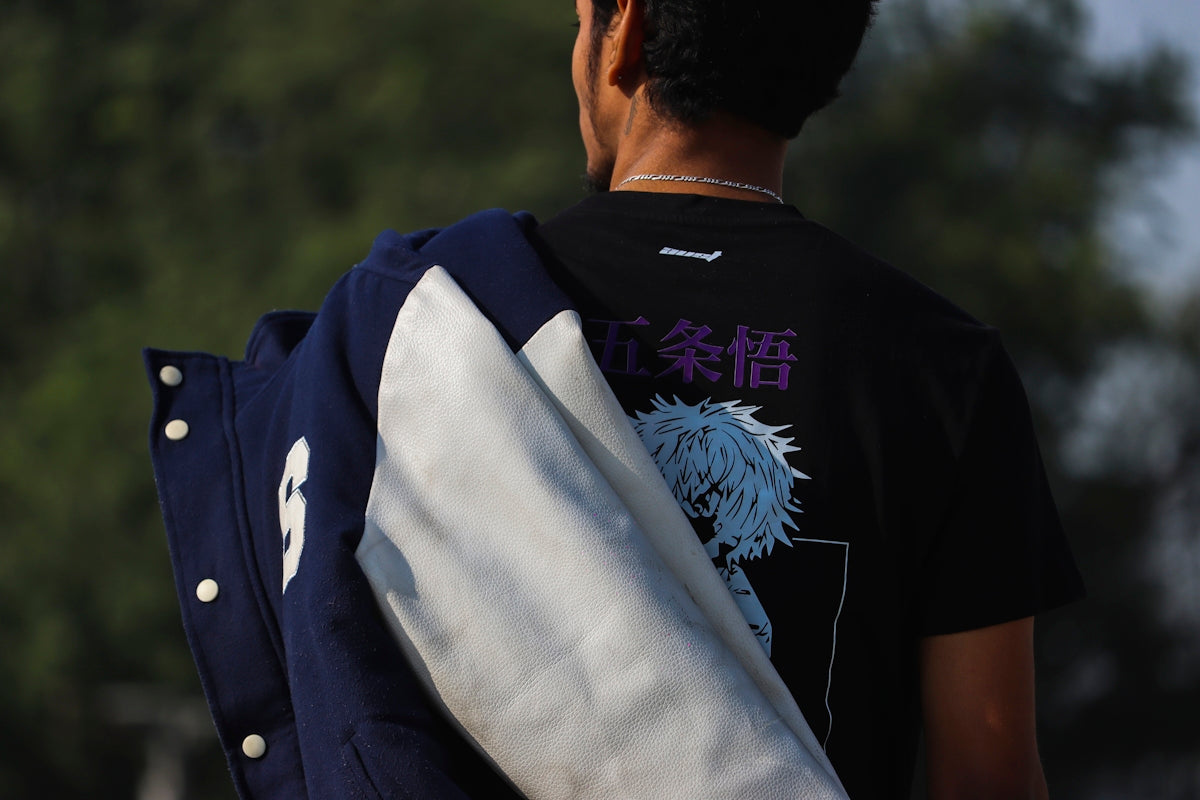 a man wearing a black shirt carrying a blue and white backpack