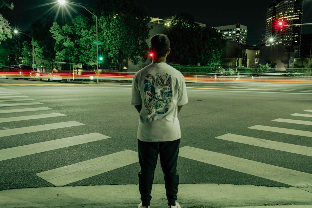 a man standing on the side of a road at night